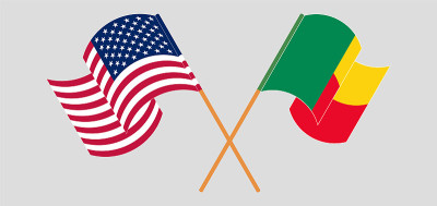 Crossed and waving flags of Benin and the USA