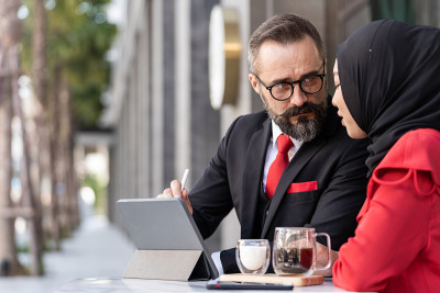 senior man in smart business suit talking to islam