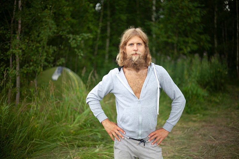 A guy with a big beard. The man travels in nature.