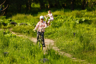 Happy little girl with her bicycle