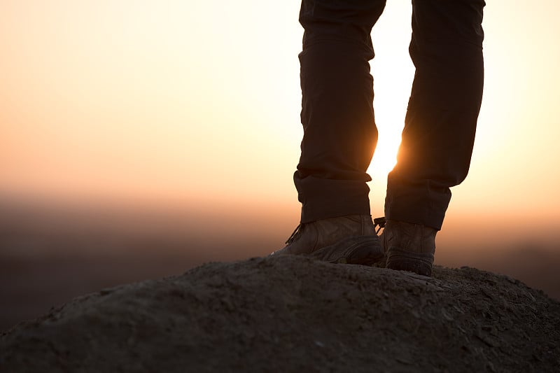 Successful woman hiker enjoy the view on sand dese