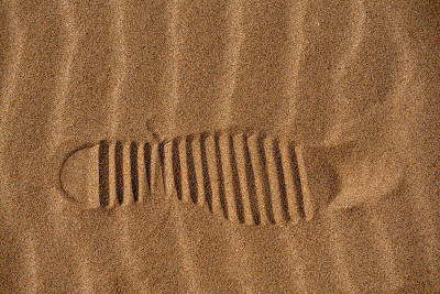 Track on abstract sand patterns in the desert