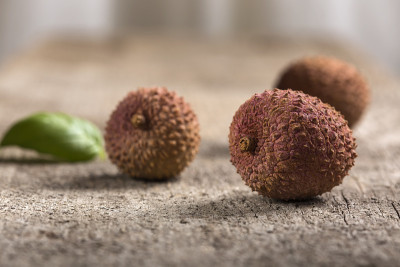 ychees fruit on old wooden background