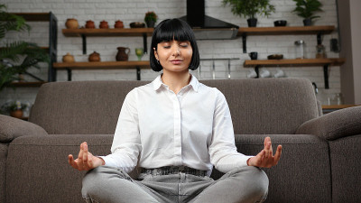 赤脚女子在地板上莲花坐姿冥想