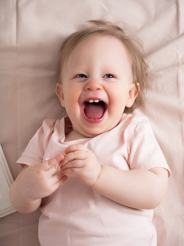 Portrait of a happy laughing baby, with a funny ex