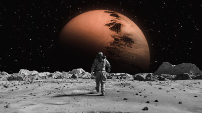 勇敢的宇航员穿着宇航服在月球上自信地走向太空星球，身上覆盖着岩石。第一位登上月球表面的宇航员。人类的
