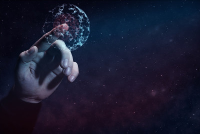 人的食指触碰细胞分裂。无限空间中的星云尘埃。混合媒体。