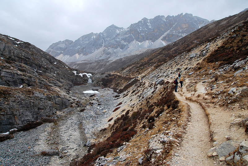 徒步登山之路在亚丁自然保护区公园，去看山顶上的奶湖，中国四川稻城县徒步史诗般的山脉和冒险