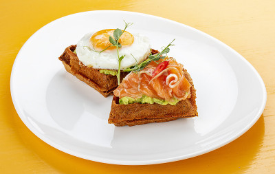 American waffle with salmon and egg, with avocado 