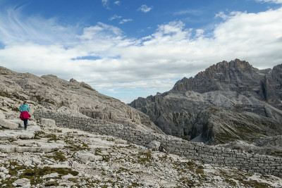 Oberbachernspitze -一个女人徒步旅行在一个高和荒凉的山在意大利白云石。
