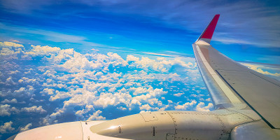 飞机机翼掠过天空背景，