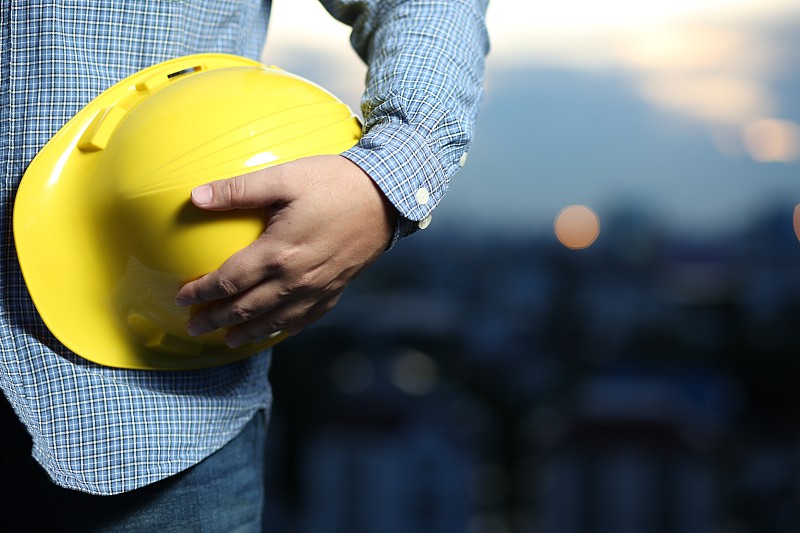 Engineer holding a safety helmet