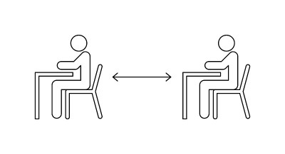 在学校保持安全距离的概念。两个学生坐在桌子旁保持社交距离。行图标。