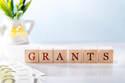 GRANTS word written on wooden cube blocks on white