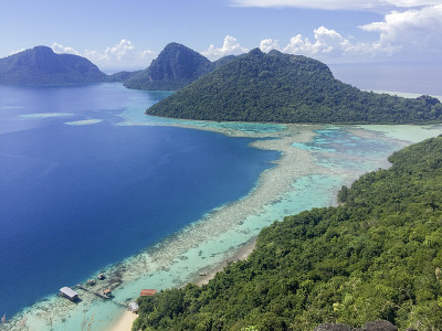 从最令人惊叹的山峰Bohey Dulang上鸟瞰蔚蓝的大海，海水、珊瑚、山和天空的图案。