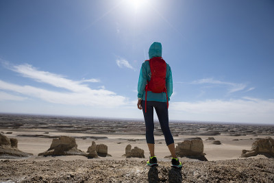 Successful woman trail runner on sand desert dunes
