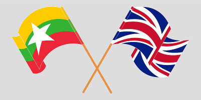 Crossed and waving flags of Myanmar and the UK