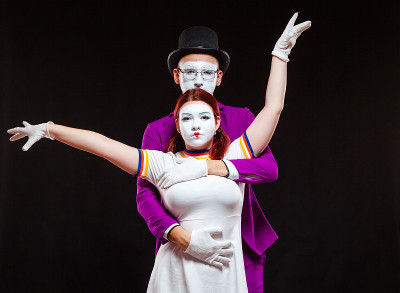 Portrait of two mime artists, isolated on black ba