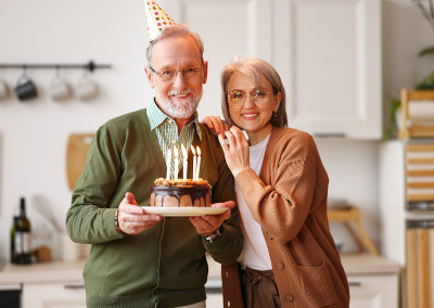 老夫妇用蛋糕庆祝生日和结婚纪念日