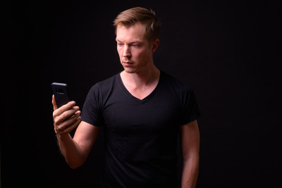 Studio Portrait Of Man Against Black Background Us