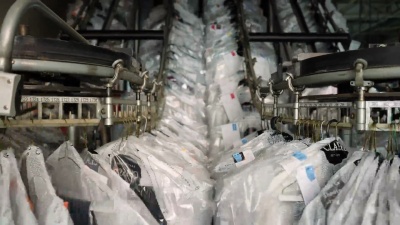 挂在传送带上的衣服在工业洗衣服务中移动