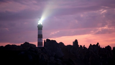 粉红色夕阳下的强大灯塔