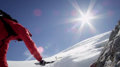 登山者在白雪覆盖的山上攀登