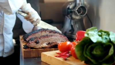在木板上切一大块熏肉