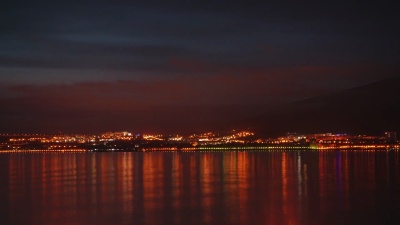 延时摄影。美丽的夜空笼罩着夜晚的城市和大海。