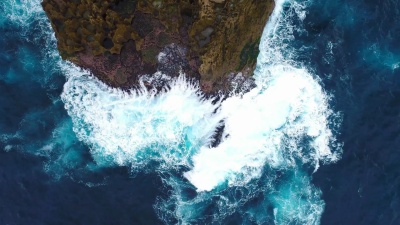 印度尼西亚努沙佩尼达，海浪冲击岩石海岸的悬崖。