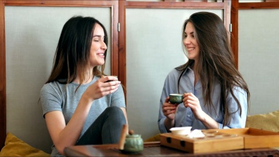 两个漂亮的女朋友在咖啡馆聊天喝茶