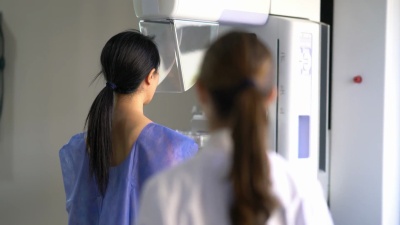 友好的医生给一位女性病人做乳房X光检查