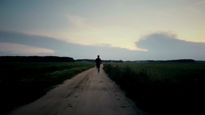 运动员跑向令人惊叹的日出全景。年轻运动员的背影。生命中最美好的时刻。电影结束镜头