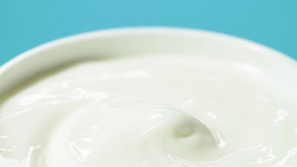 Close-up of cosmetics cream on blue background