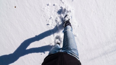 男人在刚下的雪上穿着雪鞋