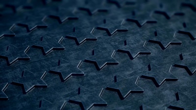 五颗金色的星星出现在黑色的浮雕表面上。