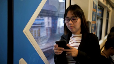 曼谷火车上使用智能手机的女商人