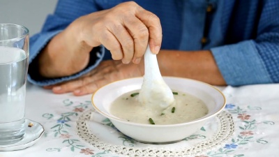 年长的亚洲妇女对食物感到厌烦