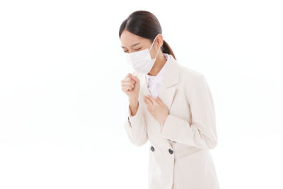 人物系列实景一手捂着胸口一手握拳难受咳嗽的职业女性
