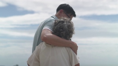 Side View Happy senior asian woman and her middle aged son embracing