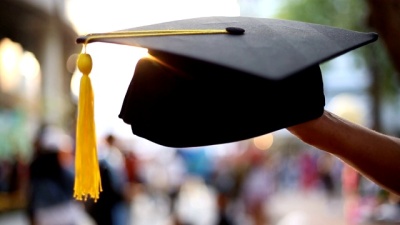 Graduation cap in the hands of graduates