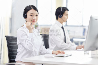 人物系列写实坐在办公室的电脑前为客户解答的女性客服