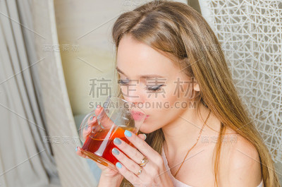 在一个迷人的女孩喝着茶的家庭气氛中