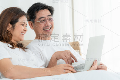 快乐的亚洲老年夫妇有美好的时间在家里。老年人退休与健康公民老年观念。