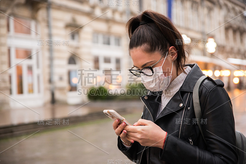 戴着面具的女人黄昏时分在街上打电话