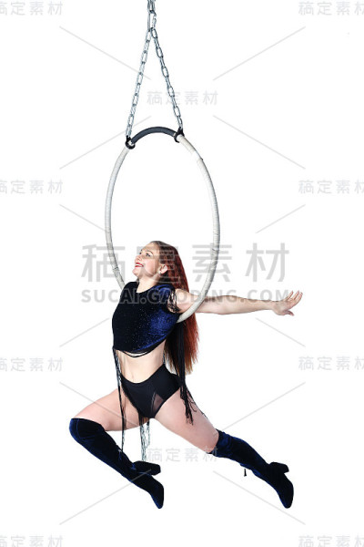 空中杂技演员。年轻快乐的女孩在空中表演杂技元素。工作室拍摄，在白色背景上孤立。