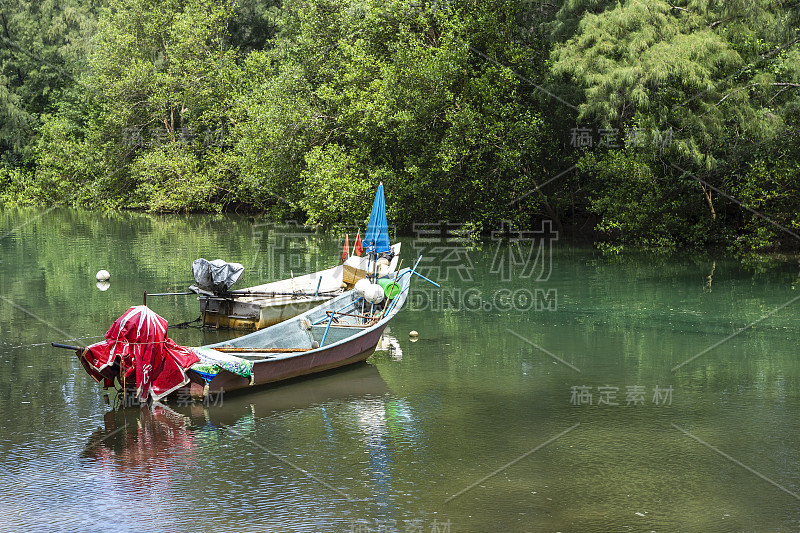 河上的渔船被绿树环绕着