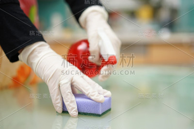 保洁公司的女佣正在用海绵清洁厨房