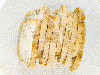 桌上放着切片的亚麻籽白面包。