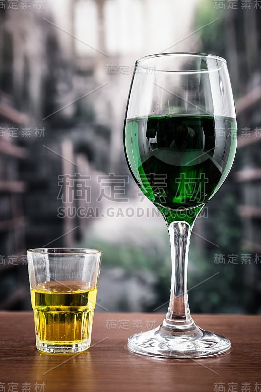 杯子里有绿色的鸡尾酒和黄色的烈酒